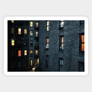 Illuminated windows in New York City courtyard at twilight Sticker